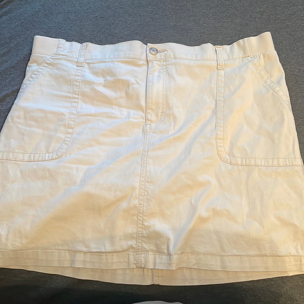 A cute skirt that is amazingly matched with a simple top and vans.